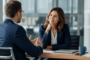 Business professionals engaged in a conference room discussion, demonstrating active listening, collaboration, and strategic decision-making during a UCaaS vendor evaluation.